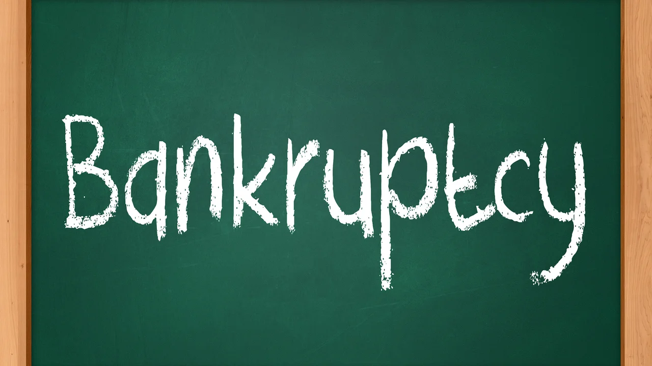 Close up on a plate of mashed potatoes, topped with baked pork chops with cream of mushroom soup, and a side of green beans.