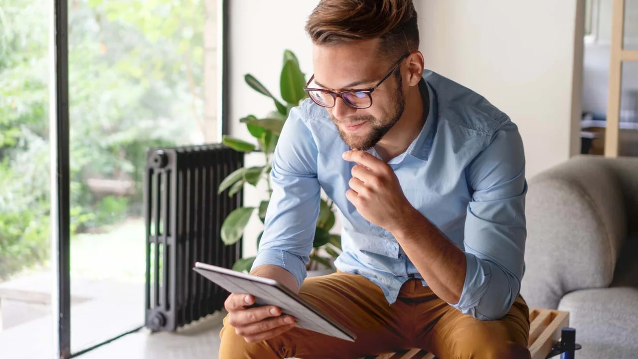Close up on a plate of mashed potatoes, topped with baked pork chops with cream of mushroom soup, and a side of green beans.